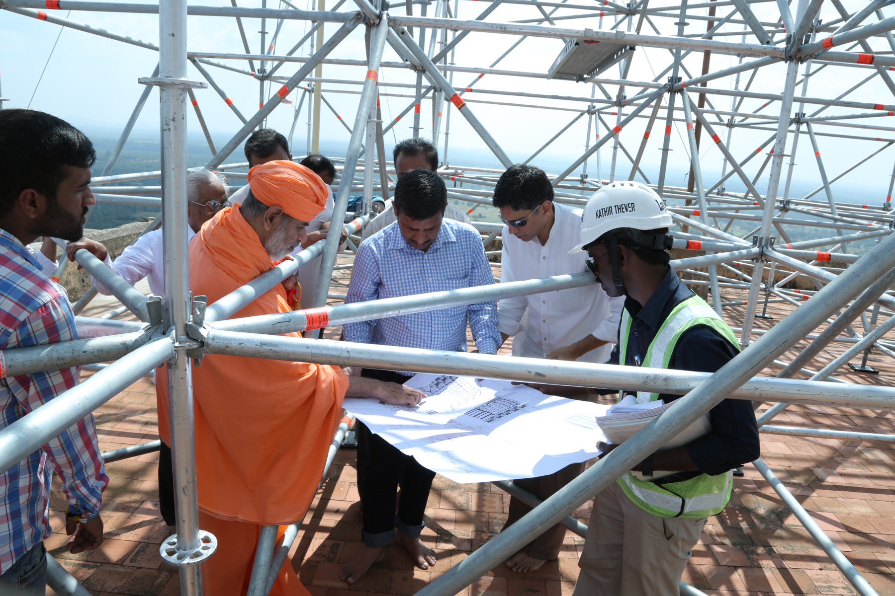 Review of scaffolding engineering blueprints with Swamiji atop Vindhyagiri